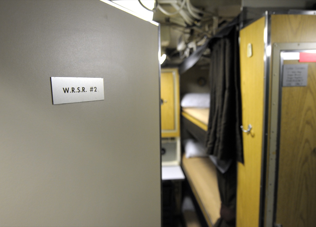 Submarine berthing compartment showing stacked bunks in a narrow passageway