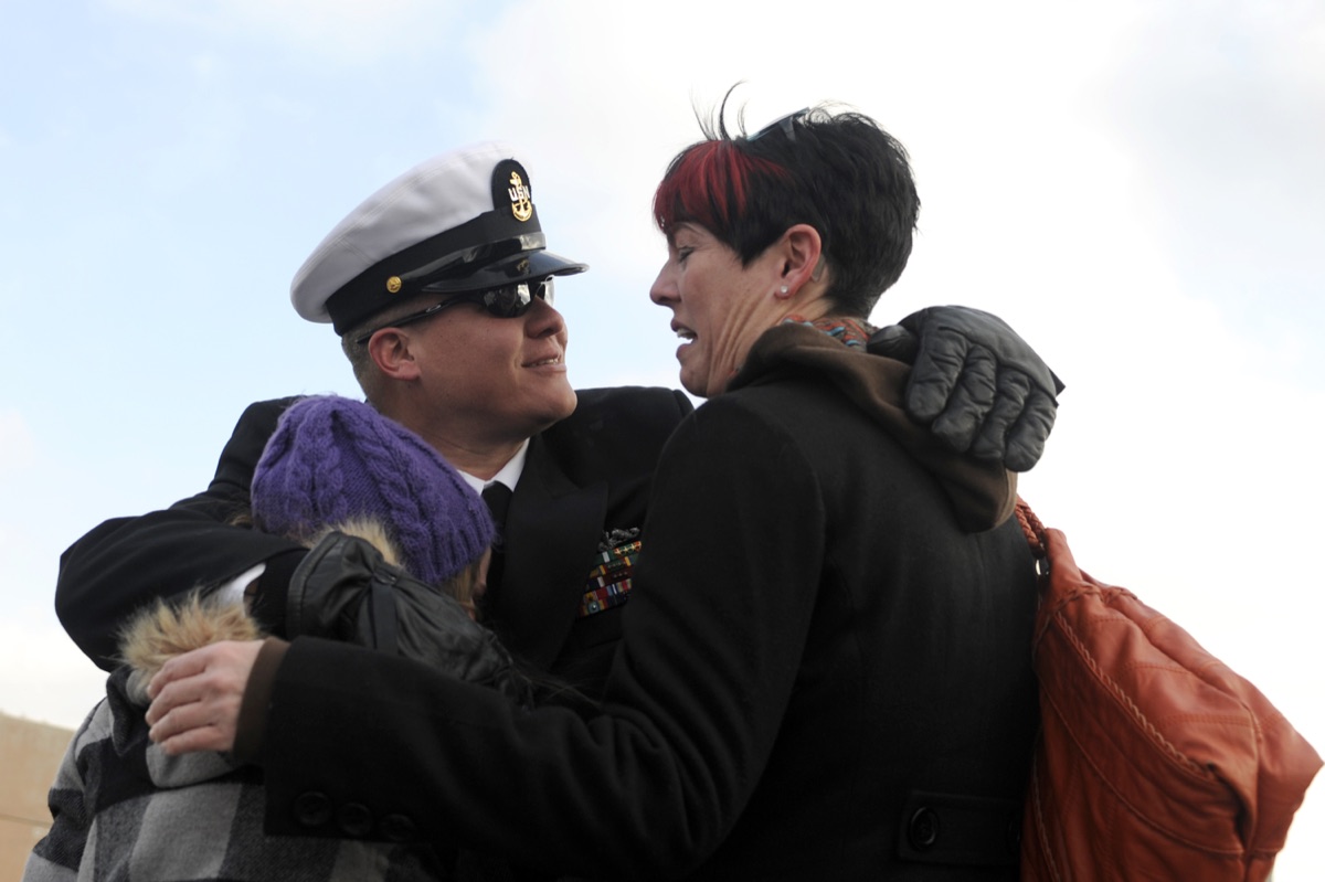 Submarine crew members greeting families on the pier after returning from a strategic patrol
