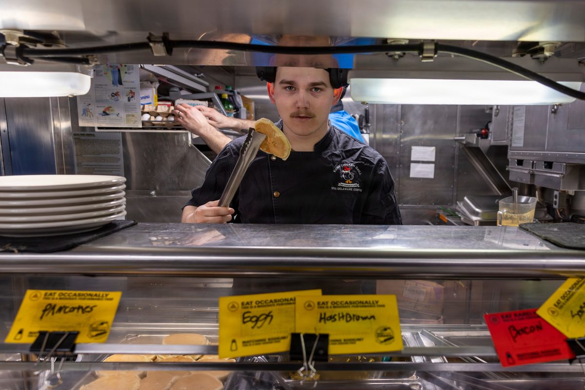 Submarine culinary specialists preparing meals in the boat's galley kitchen