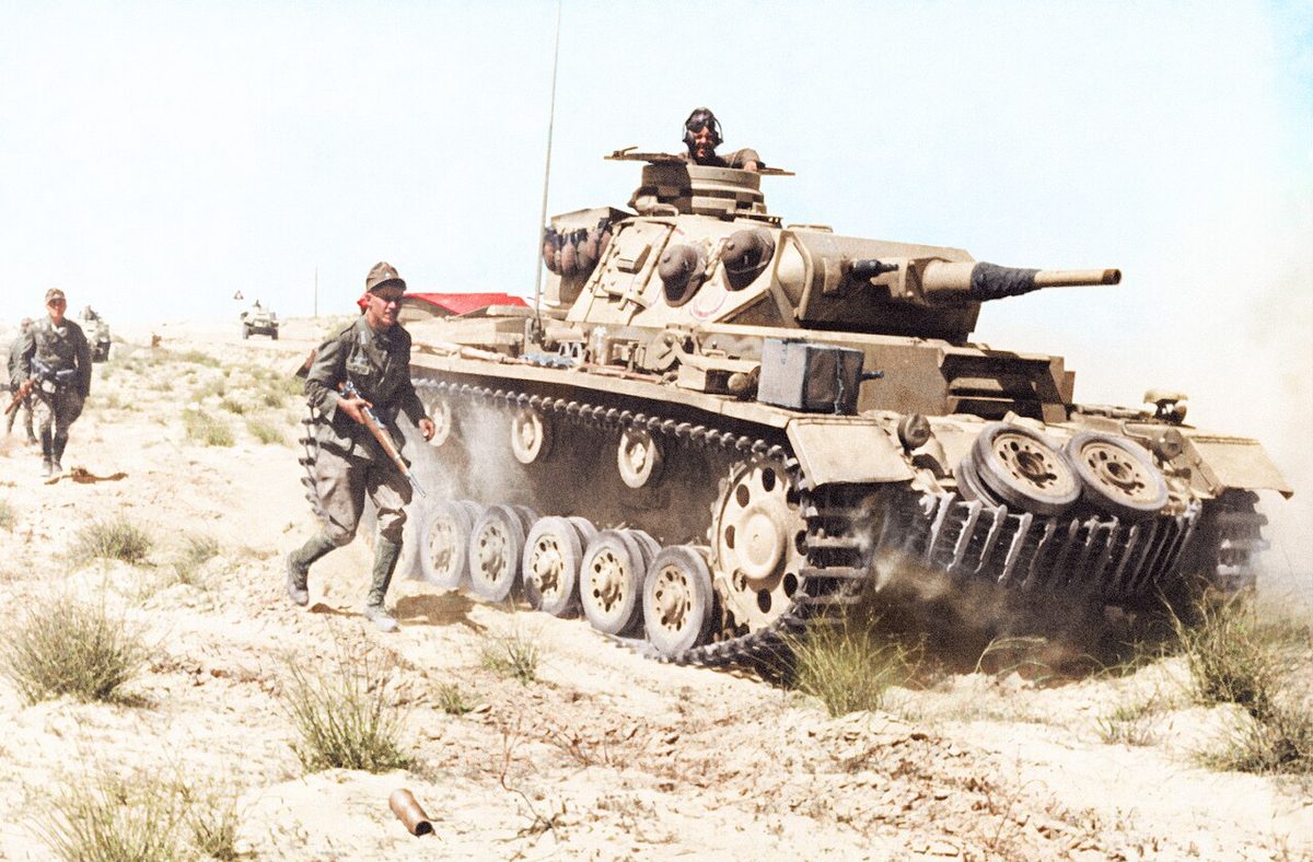 German Afrika Korps Panzer III tank advancing through the North African desert