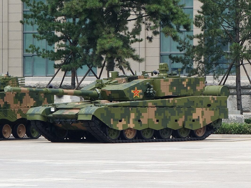 Type 99A tanks during a military parade showing the arrowhead turret design and integrated ERA