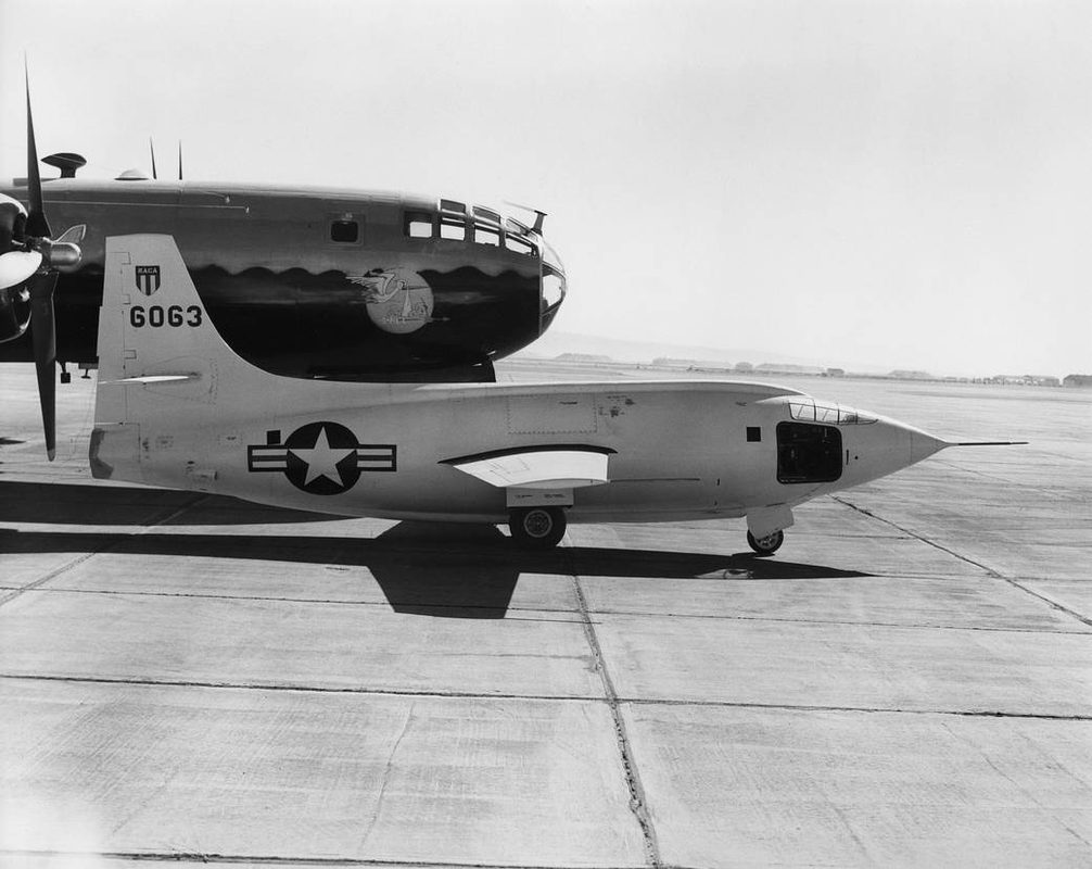 Bell X-1 mounted under the B-29 Superfortress mothership on the ground before a flight