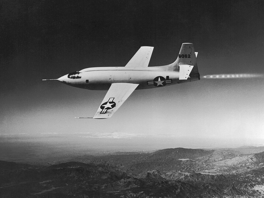 Bell X-1 in flight with rocket exhaust visible during a high-speed test run