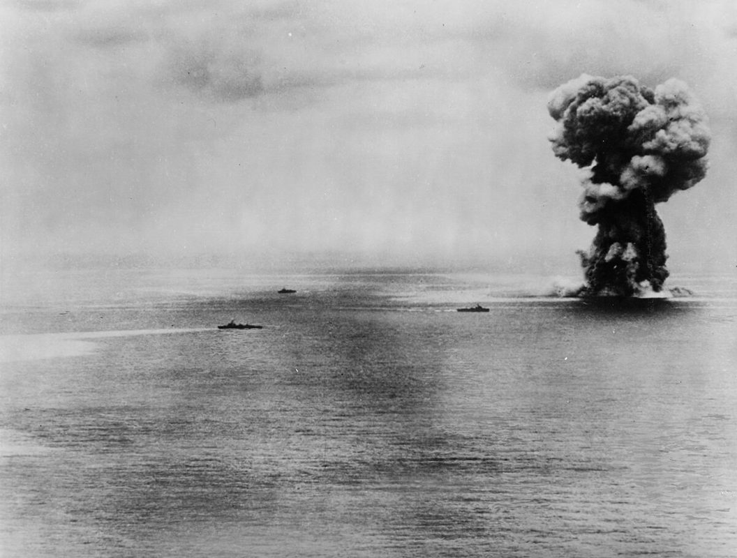 Massive mushroom cloud rising from the ocean surface marking the final explosion of battleship Yamato