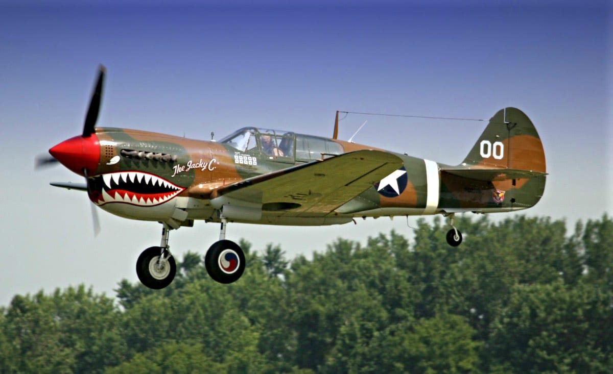 Curtiss P-40 Warhawk in flight with shark mouth nose art