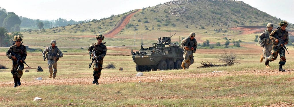 CAMP BUNDELA, India (Oct. 15, 2009) - Indian Army Soldiers assigned to the 94th Armored Brigade along with U.S. Army Soldiers assigned to Troop C, 2nd Squadron, 14th Cavalry Regiment “Strykehorse,” 2nd Stryker Brigade Combat Team, 25th Infantry Division, from Schofield Barracks, Hawaii charge the uphill range during Exercise Yudh Abhyas 09, Oct. 15. YA09 is a bilateral exercise involving the Armies of India and the United States.