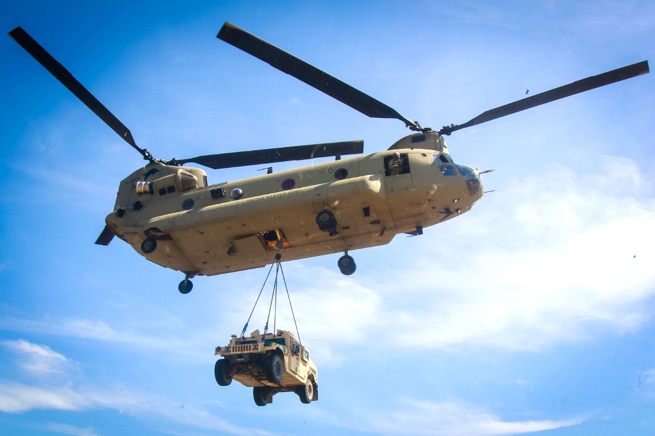CH-47 Chinook lifts Humvee