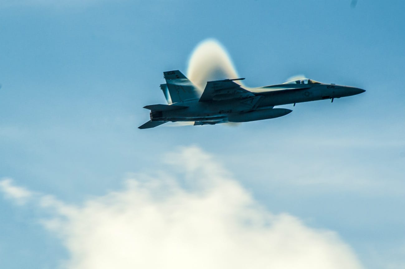 FA-18E Super Hornet breaks the sound barrier over the aircraft carrier USS George Washington
