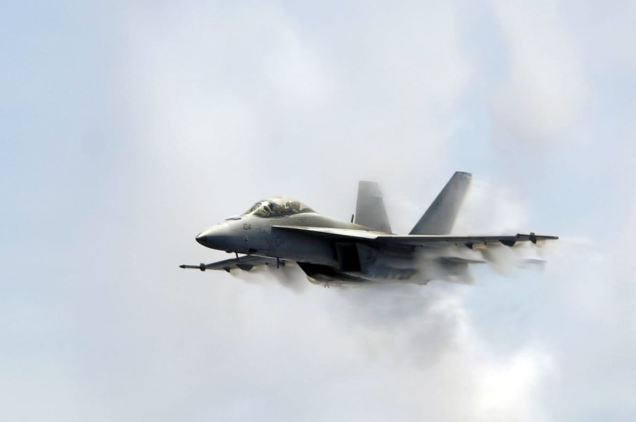 FA-18F Super Hornet punches through a cloud of water vapor while breaking the sound barrier