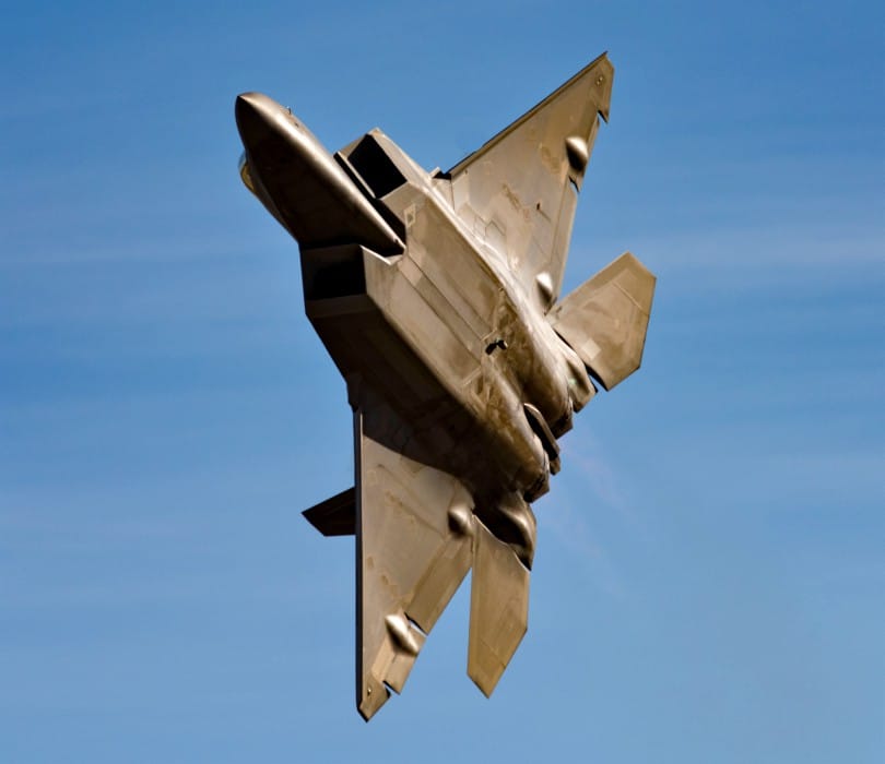 F-22 Raptor in flight showing its distinctive twin-tail and stealth profile