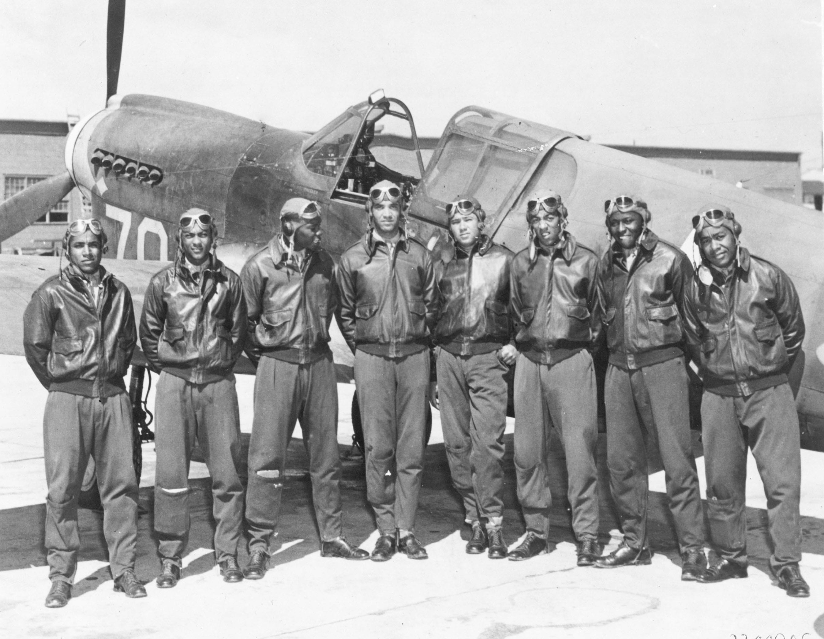 Tuskegee Airmen in front of a P-51 Mustang