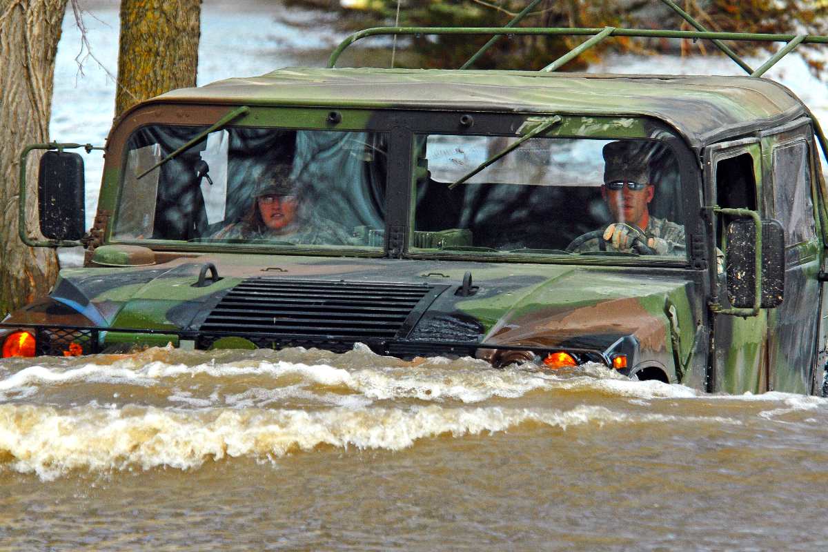 U.S. Army Staff Sgt. William Griffin, with the 136th Combat Sustainment Support Battalion, drives a Humvee on a flooded road in Fort Ransom, N.D., April 15, 2009. Griffin and Spc. Jessica Sandberg, with the 132nd Quartermaster Battalion, are making a welfare visit to a rural civilian whose home is surrounded by water. 