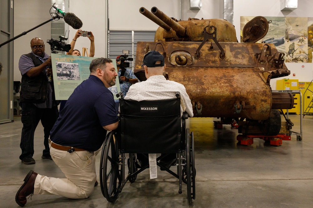 World War II Sherman tank displayed with veteran at museum event