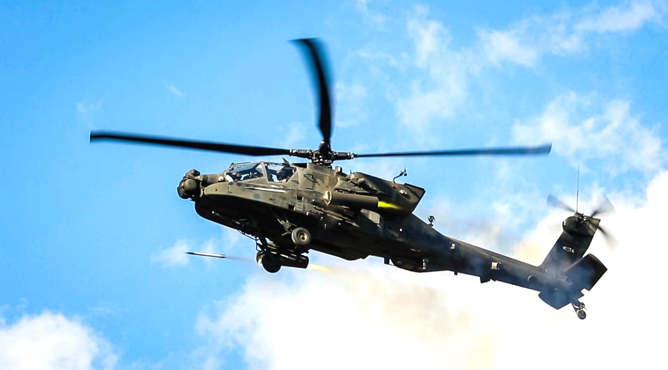 Apache Attack Helicopter fires missiles