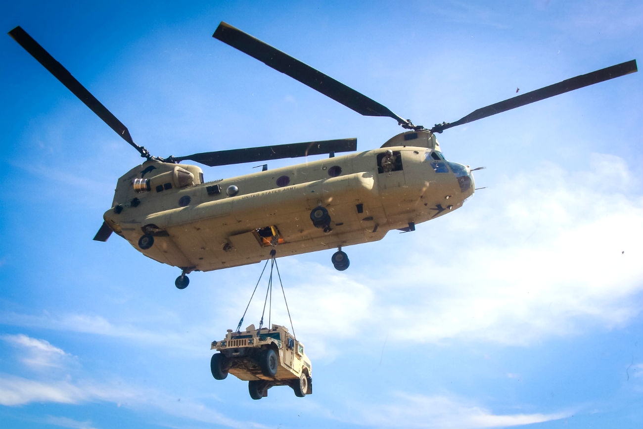 CH-47 Chinook lifts Humvee