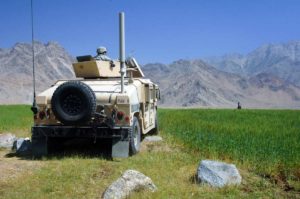 A U.S. Army Soldier from Alpha Company, 13th Psychological Operations Battalion pulls security from a humvee at a vehicle control point in the village of Kapisa, Afghanistan, May 15, 2007.